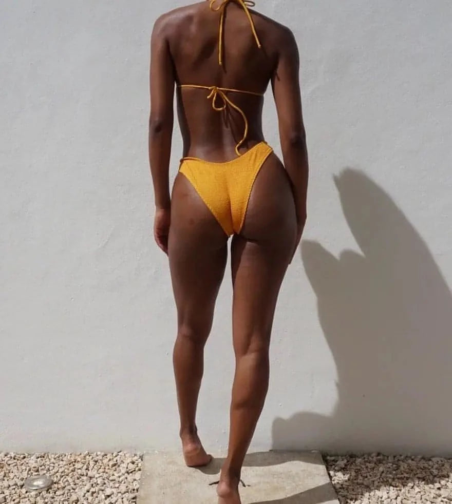 Gsaints model wearing tingle bikini top in turmeric 